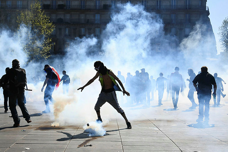 Protesters stand amid tear gas at the Place de la Republique during an anti-government demonstration called by the ‘Yellow Vests’ (gilets jaunes) movement, on April 20, 2019 in Paris. — AFP