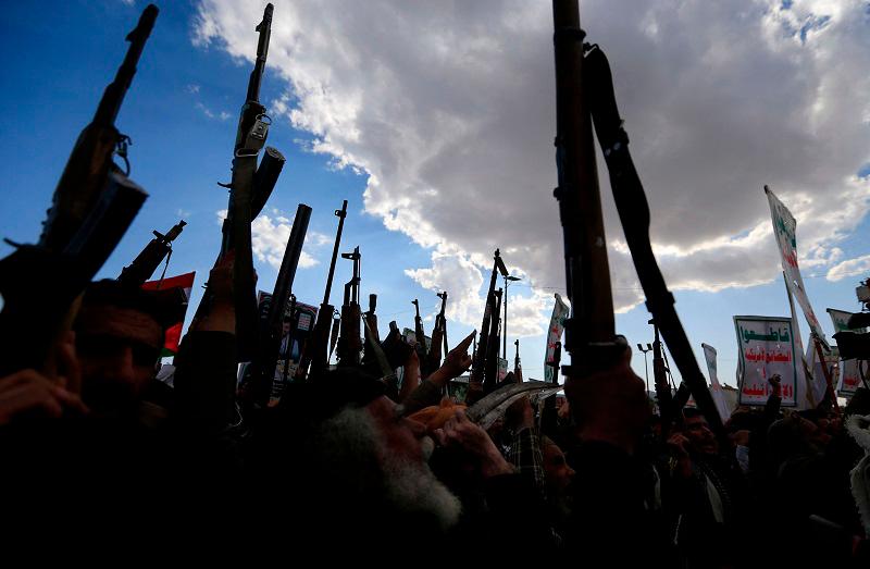 Yemenis brandish rifles and chant during a demonstration called for by the rebel Huthi movement in Sanaa on March 17, 2025. Huge crowds joined protests in rebel-controlled Yemen on March 17 after deadly US strikes killed dozens and sparked fears of a new cycle of violence in the conflict-torn country. - Mohammed HUWAIS / AFP