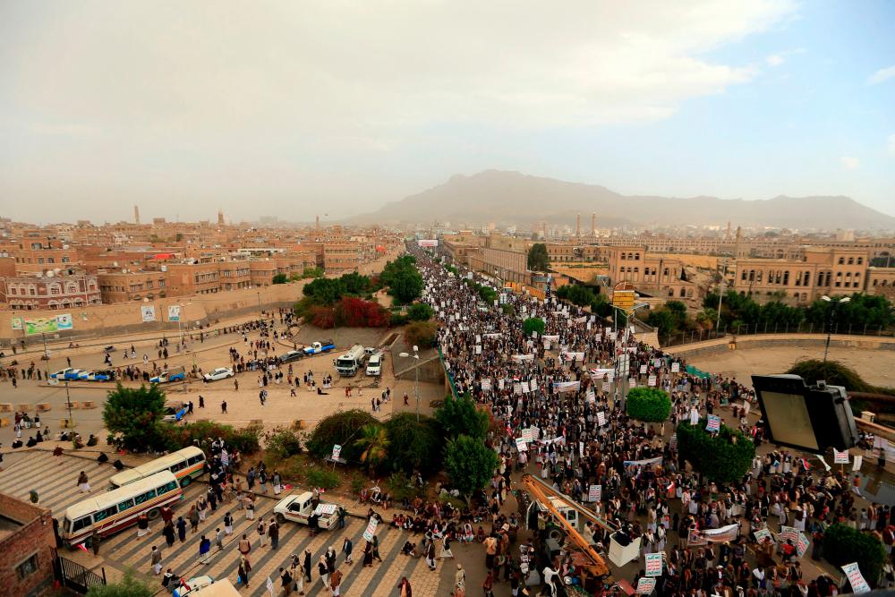 Supporters of the Yemeni Houthi rebels take to the steets of the capital Sanaa to protest against the blockade imposed on their country by the Saudi coalition, on February 26, 2021. - AFP