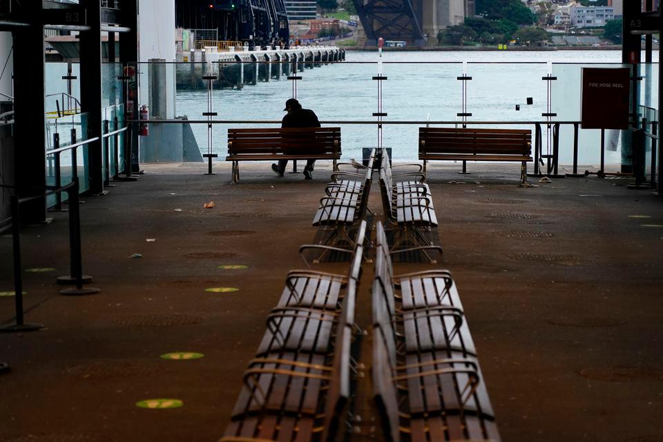 A lone man sits on a bench at the quiet Circular Quay during a lockdown to curb the spread of a coronavirus disease (Covid-19) outbreak in Sydney, Australia, July 28, 2021. -Reuters