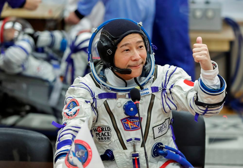 Japanese entrepreneur Yusaku Maezawa reacts as he speaks with his family after donning space suits shortly before the launch to the International Space Station (ISS) at the Baikonur Cosmodrome, Kazakhstan, December 8, 2021. REUTERSpix