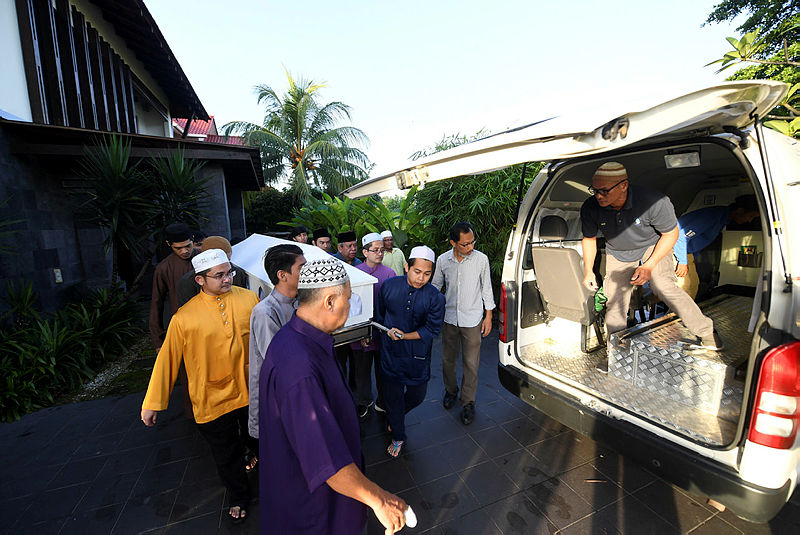 The remains of Zainuddin Maidin is brought out of his home in Putrajaya to be taken to the Surau At Tarbiah in Taman Melawati, this morning.
