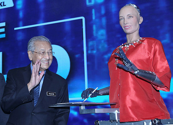 Prime Minister Tun Dr. Mahathir Mohamad waves his hand to Sophia ‘The Robot’ after the official opening ceremony on Beyond Paradigm Summit 2019 at MITEC today.