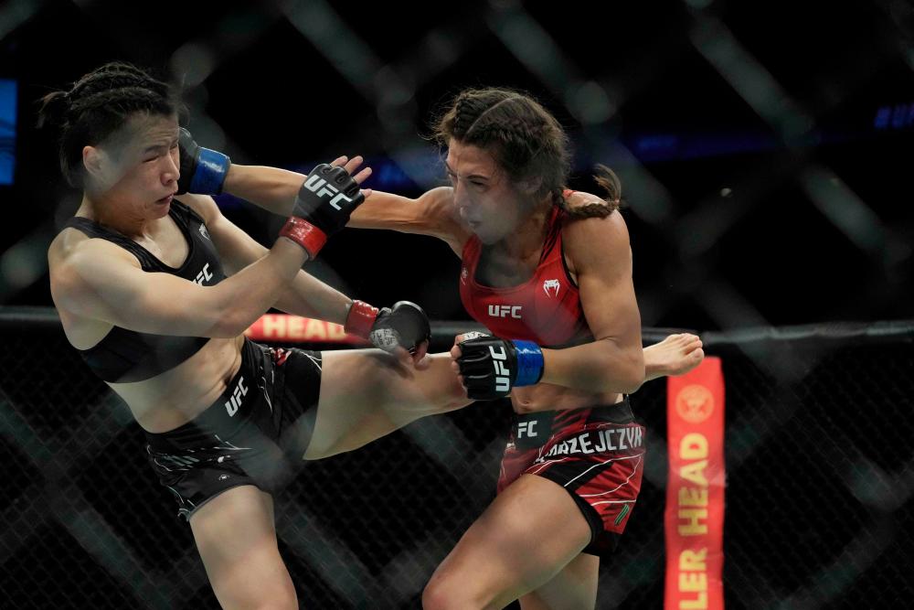 Zhang Weili (left) competes with Joanna Jedrzejczyk (right) in the women’s strawweight bout during their UFC 275 event in Singapore. - AFPPIX