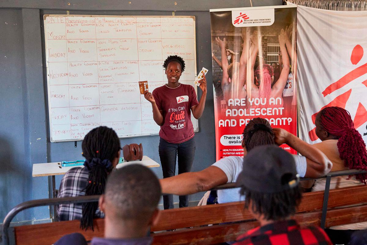 Ever Itai Ndondovedzai, a peer educator with Doctores Without Borders (MSF), presents to sex workers a talk on sexual reproductive health and how to properly use a condom in the informal settlement of Epworth in Harare on August 28, 2025. - Jekesai NJIKIZANA / AFP