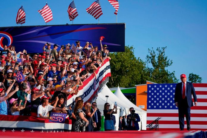 Trump celebrates tax bill victory at Iowa fairground rally