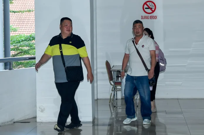 Two men plead not guilty to disrupting telco network services Two men plead not guilty to disrupting telco network services