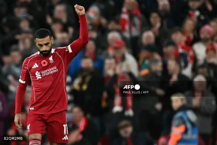 Liverpool's Egyptian striker #11 Mohamed Salah celebrates scoring the opening goal during the English Premier League football match between Liverpool and Aston Villa at Anfield in Liverpool, north west England on November 1, 2025. (Photo by Paul ELLIS / AFP)