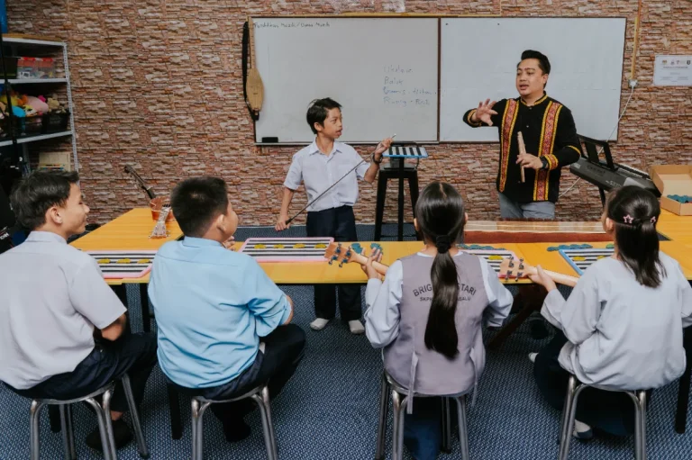 Hearing- impaired students with teacher Stefanus, who believes students need the opportunity to grow despite their disabilities.