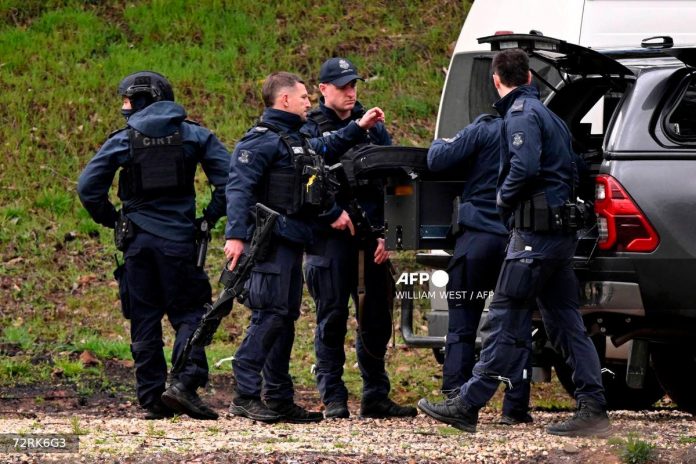 Wife of Australian man wanted in police killings urges him to surrender