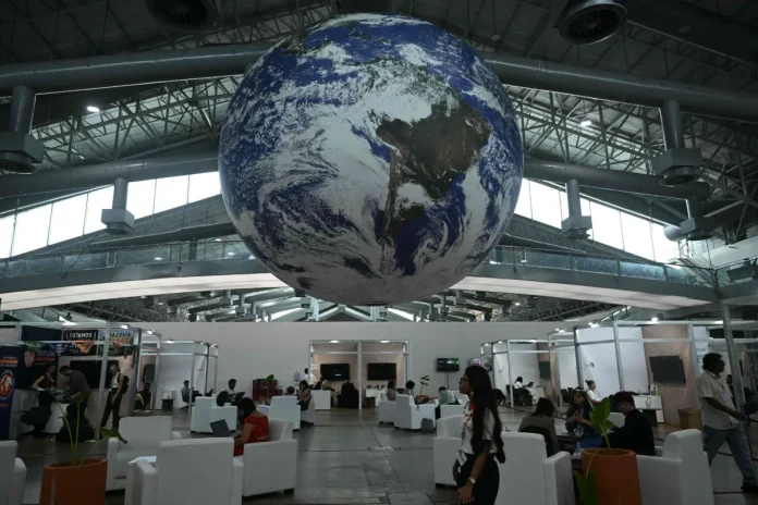 A huge globe representing the earth hangs inside a ward for NGO's and civil and social associations, at the COP30 UN Climate Change Conference premises in Belem, Para State, Brazil on November 10, 2025. - AFP pic