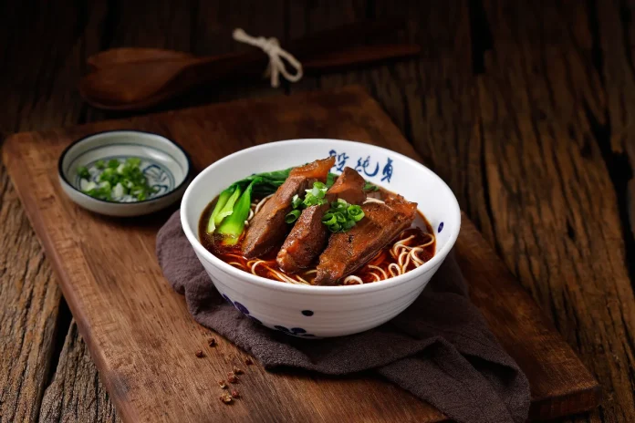Duan Chun Zhen’s signature Braised Beef Noodle Soup, featuring a rich broth simmered with over 23 herbs and spices.