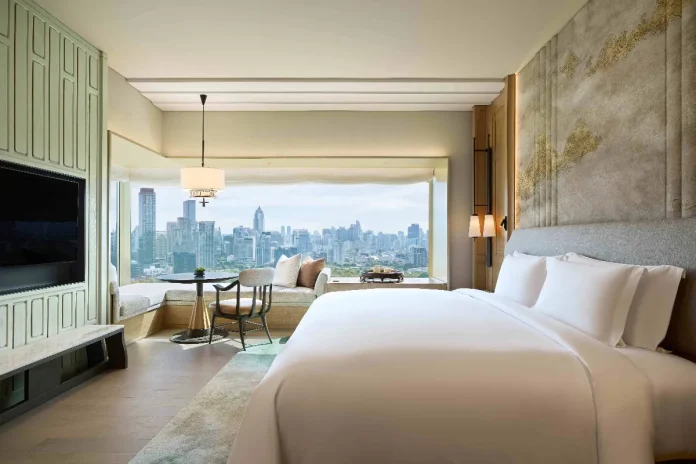 Each guest room at the reimagined Dusit Thani Bangkok offers refined comfort and panoramic views of Lumpini Park and the city skyline.
