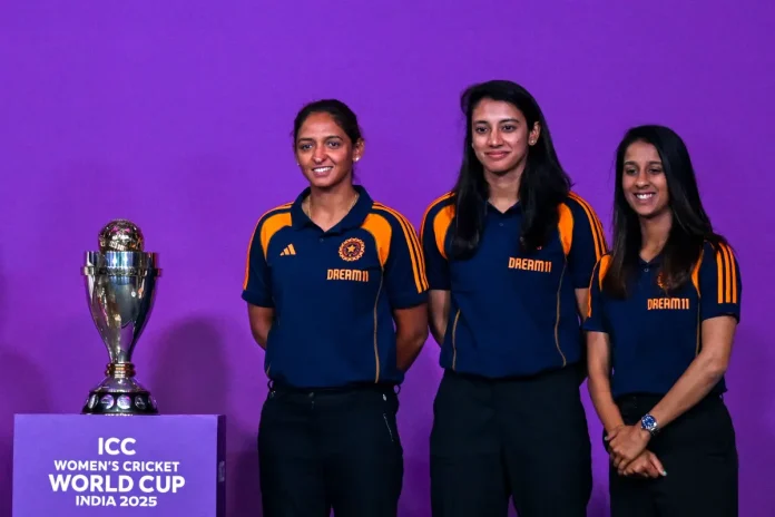 ) Indian team players Jemimah Rodrigues (R), Smriti Mandhana (C) and Harmanpreet Kaur pose with the trophy during an event held to mark 50 days countdown to the 2025 ICC Women's Cricket World Cup in Mumbai on August 11, 2025. AFP