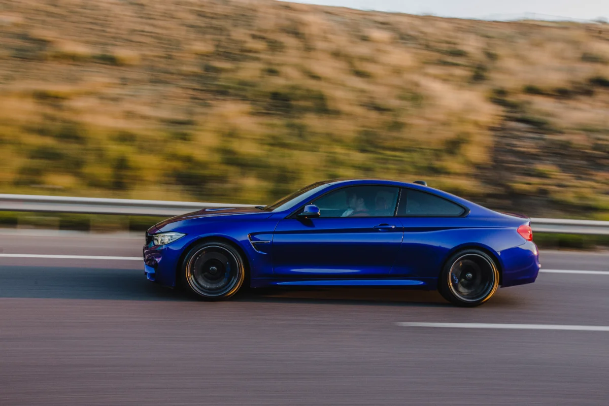 navy-blue-sport-sedan-road-side-view