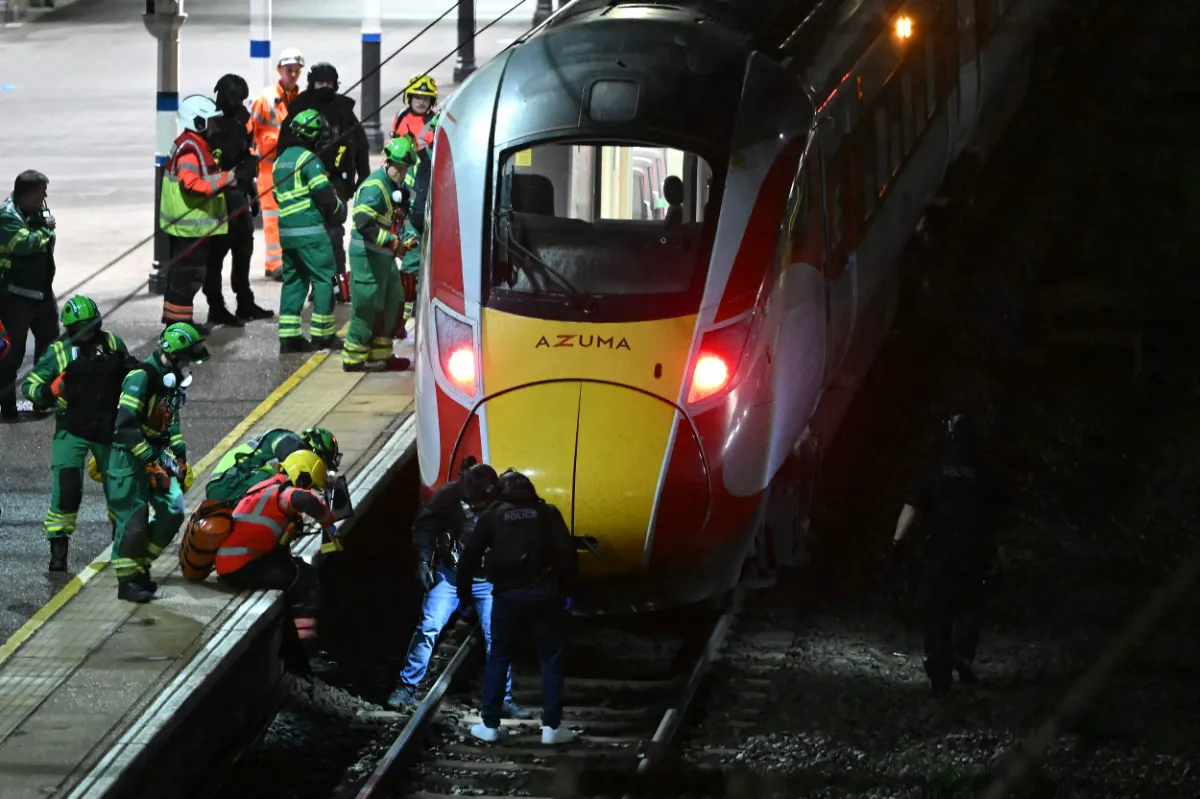 topshots-topshot-britain-crime-stabbing-001712 Police officers and members of the Emergency services search the track beneath an LNER Azuma train at Huntingdon Station in Huntingdon, eastern England, on November 1, 2025, following a stabbing on a train. UK police said they had arrested two suspects Saturday as
