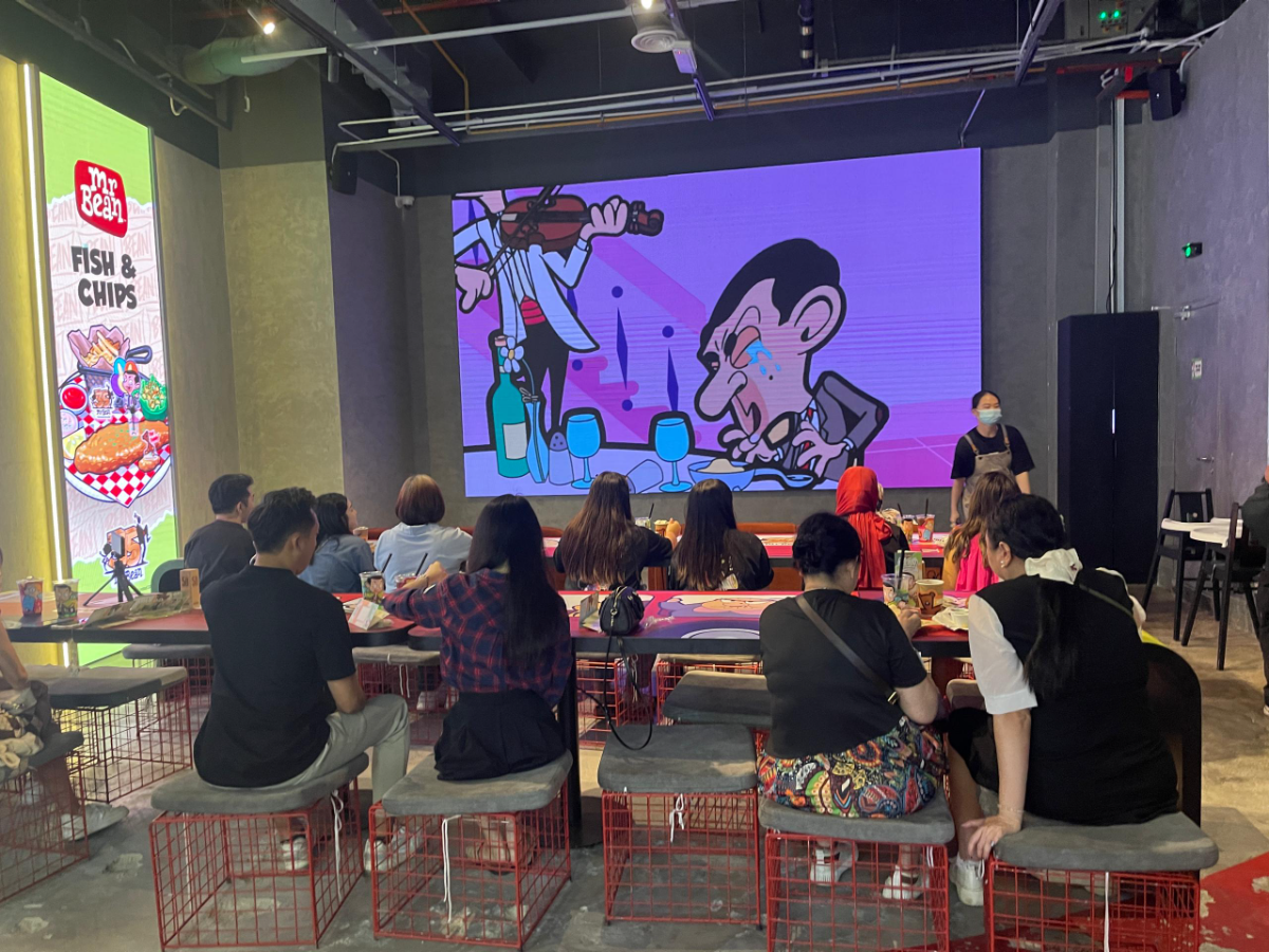 Diners at the themed cafe watching classic episodes of mr bean on the big screen while enjoying their meals. – ameen hazizi/thesun
