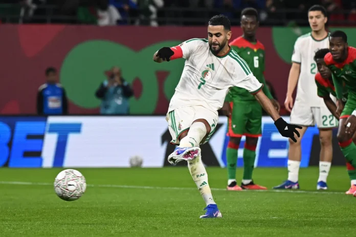 FBL-AFR-2025-MATCH_21-DZA-BFA-180217 Algeria's forward #7 Riyad Mahrez (L) shoots and scores his team's first goal from the penalty spot during the Africa Cup of Nations (CAN) Group E football match between Algeria and Burkino Faso at Moulay Hassan Stadium in Rabat on December 28, 2025. (Photo by Paul ELLIS / AFP)