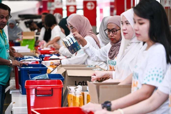 Volunteers packing hygiene care kits for flood-affected families.
