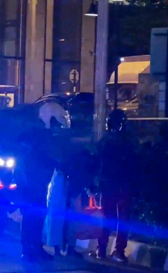 Heartwarming moment: An officer and gentlemen kindly escorts elderly woman safely across street Heartwarming moment: An officer and gentlemen kindly escorts elderly woman safely across street