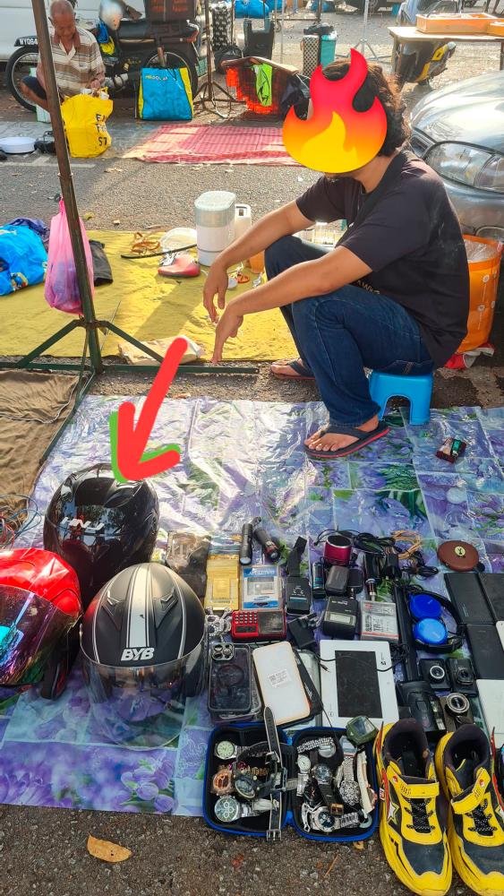 Penang woman has helmet stolen, goes to Lorong Kulit market, finds thief and helmet Penang woman has helmet stolen, goes to Lorong Kulit market, finds thief and helmet
