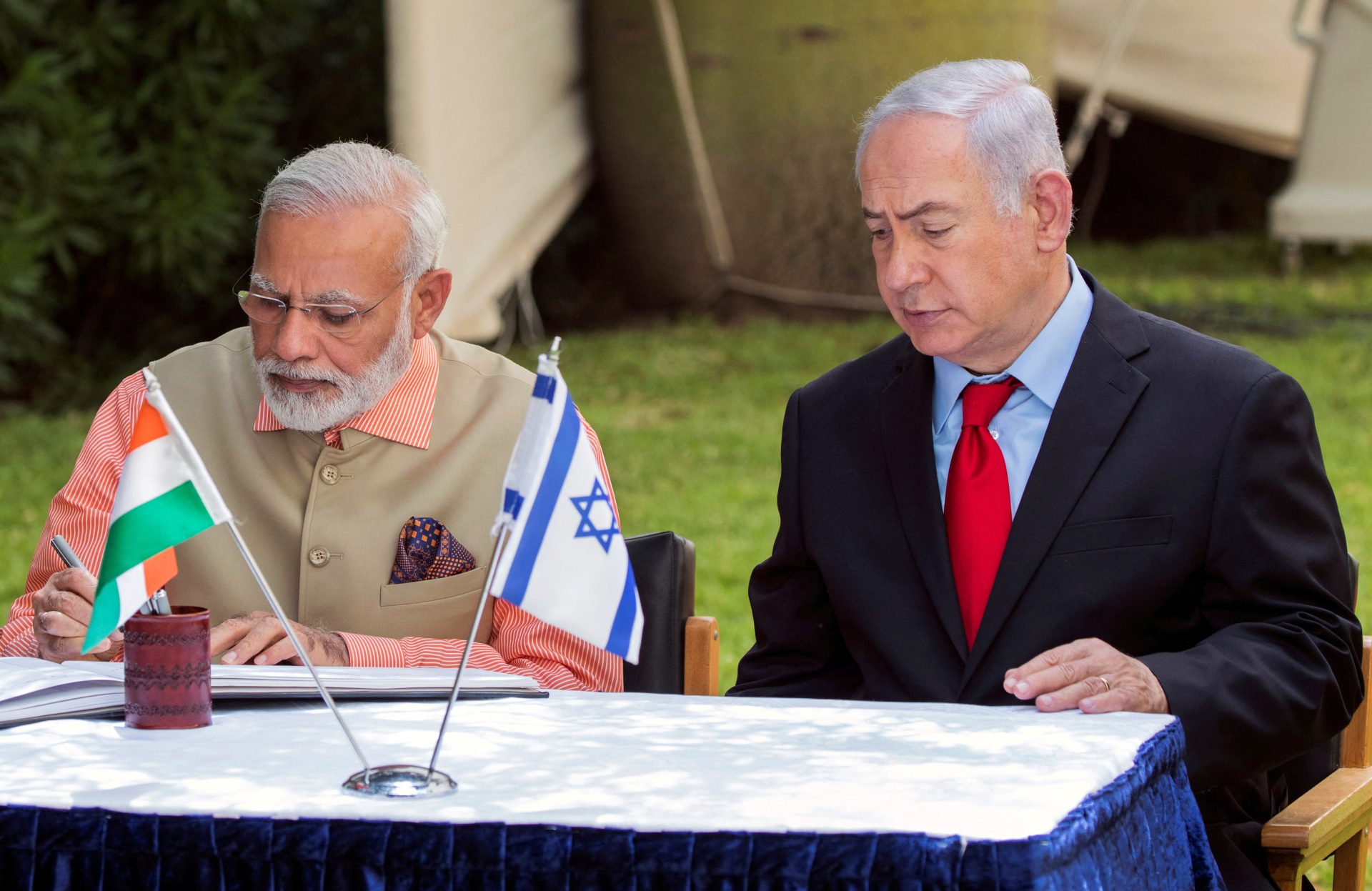 FILE PHOTO: Indian Prime Minister Narendra Modi and Israeli Prime Minister Benjamin Netanyahu sign the guest book at the Indian Army Cemetery of World War I to honour fallen Indian soldiers, in the Israeli coastal city of Haifa India's Modi visits Israel as US-Iran tensions mount