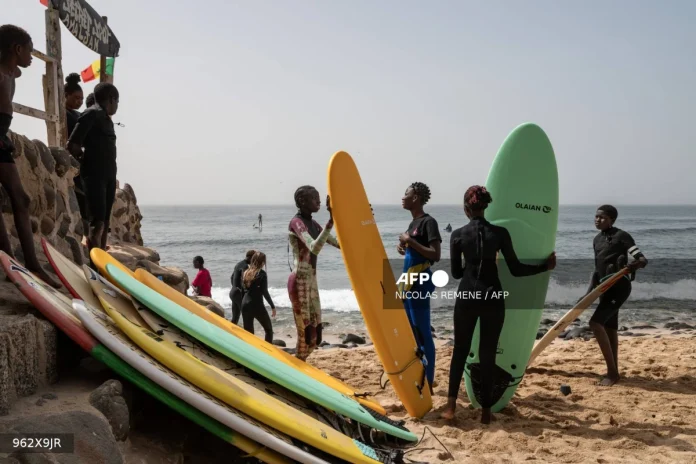 In Dakar fishing village, surfing entices girls back to school