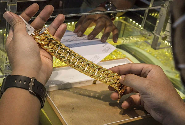 -Gold gains over 1% on soft US data, Trump's fresh tariff move