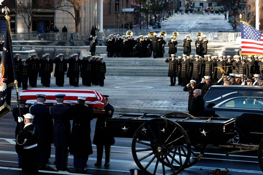 Carter body flown to snowy Washington for state funeral