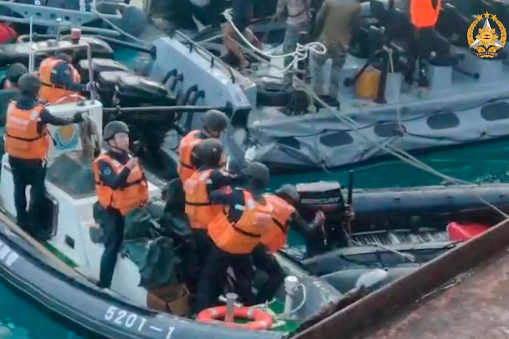 Chinese sailors wield sticks, axe in disputed sea clash with Philippines Chinese sailors wield sticks, axe in disputed sea clash with Philippines