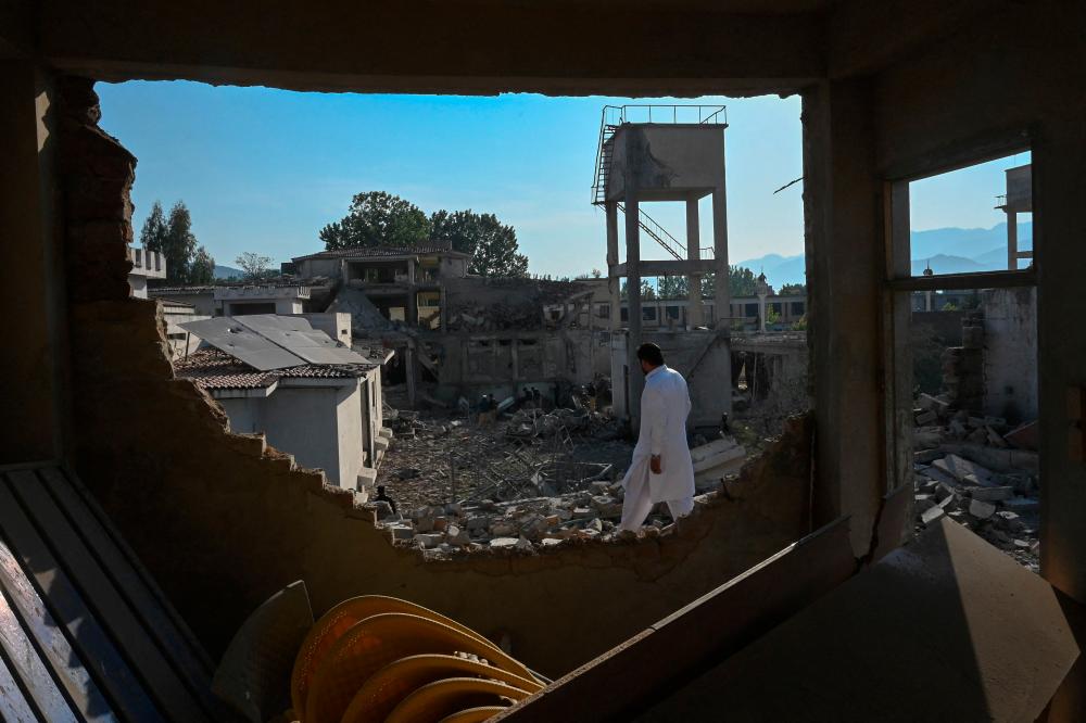 Death toll from blasts at Pakistani police station reaches 16 Death toll from blasts at Pakistani police station reaches 16