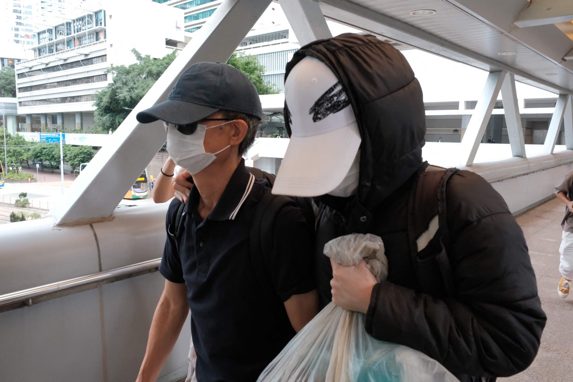 Hong Kong sentences father of wanted activist to 8 months in jail