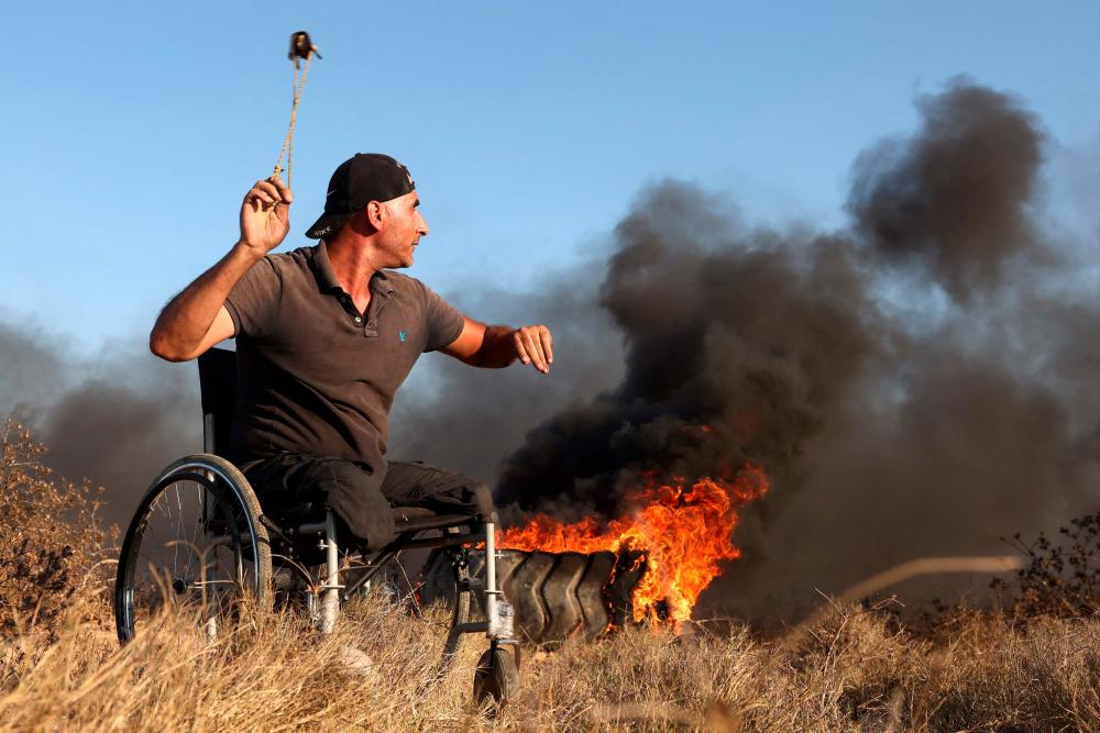 Israeli drone hits Gazan outposts as violent protests rage
