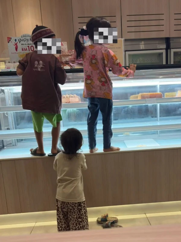 Several unruly children spotted climbing glass cake display at eatery, disrupting staff workflow