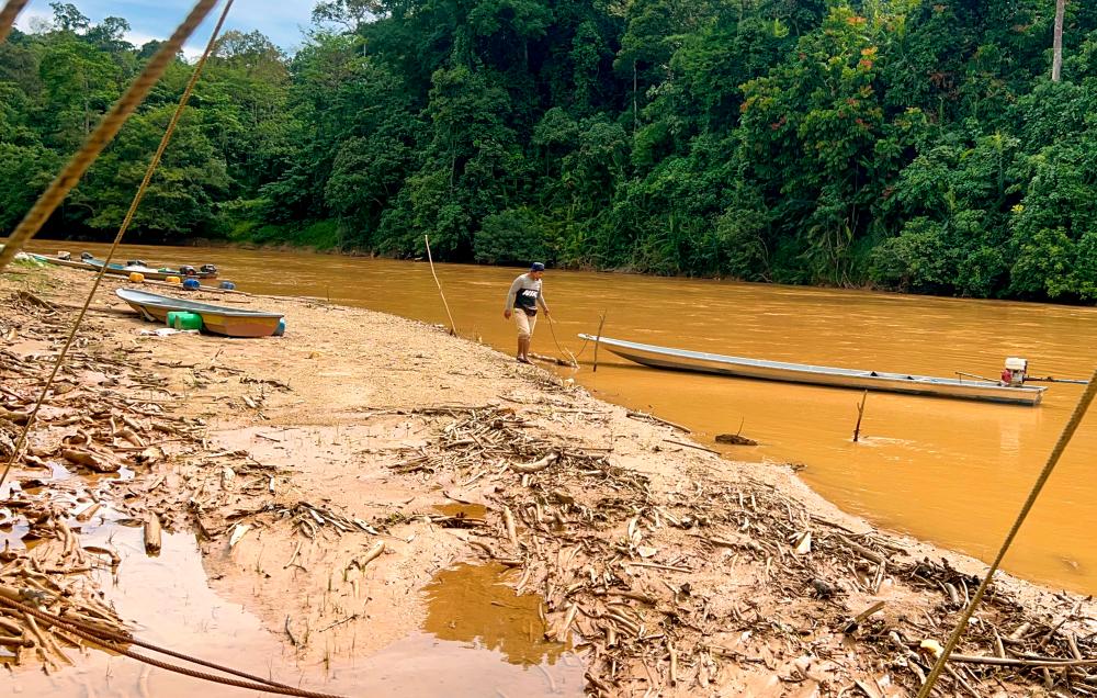 Sungai Nenggiri receding in hot weather, sandbanks and rocks emerging