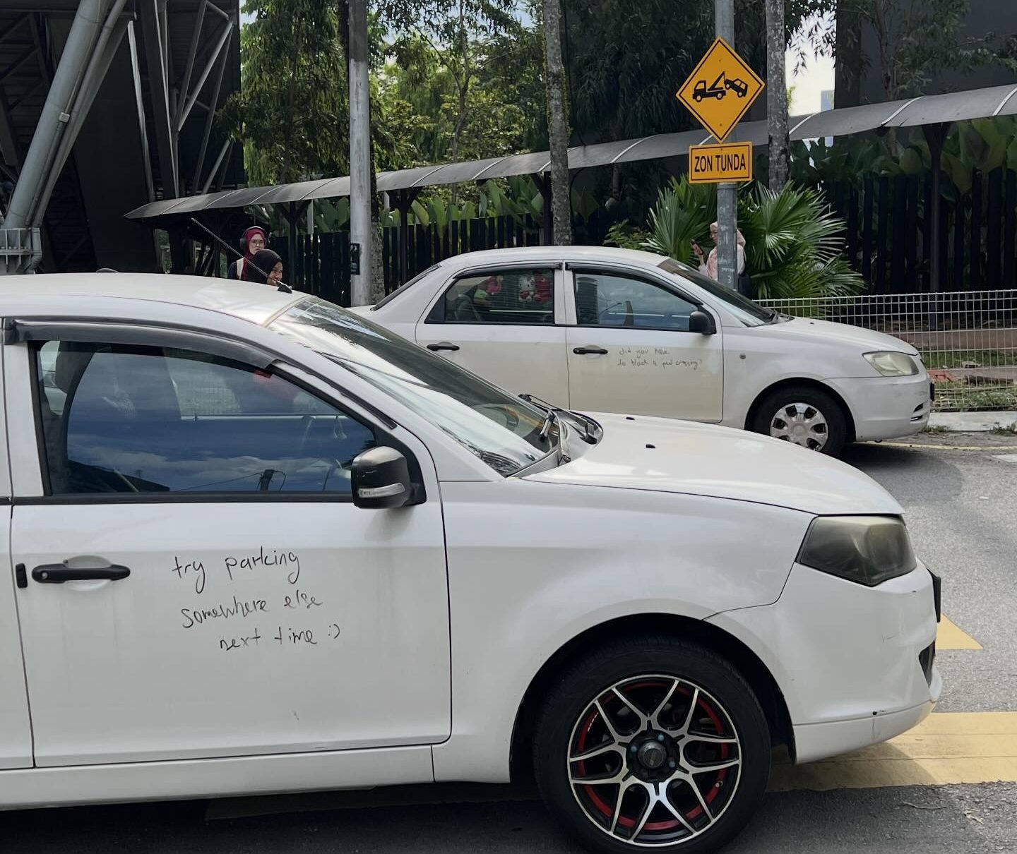 Perodua and Proton cars parked near pedestrian crossing get written reminders on vehicles Perodua and Proton cars parked near pedestrian crossing get written reminders on vehicles