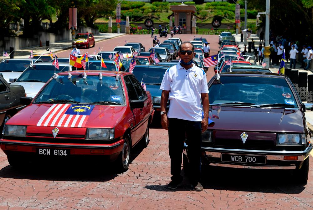 A convoy of classic Proton Saga cars stirs nostalgia on Malaysia Day