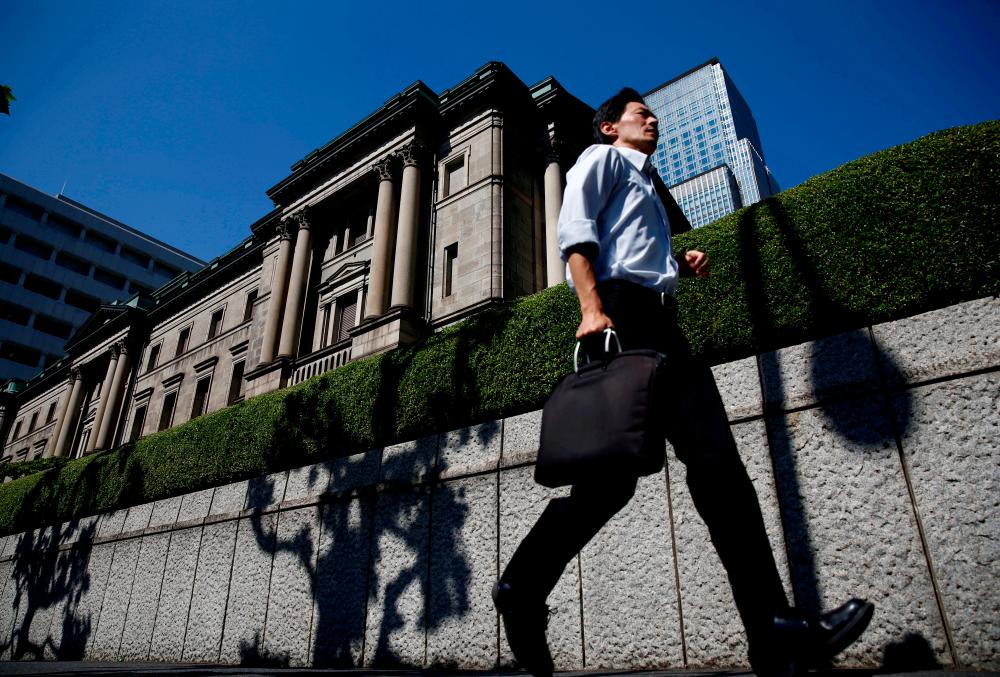 BOJ policymaker highlights cost of huge asset buying,signals tweak in March review