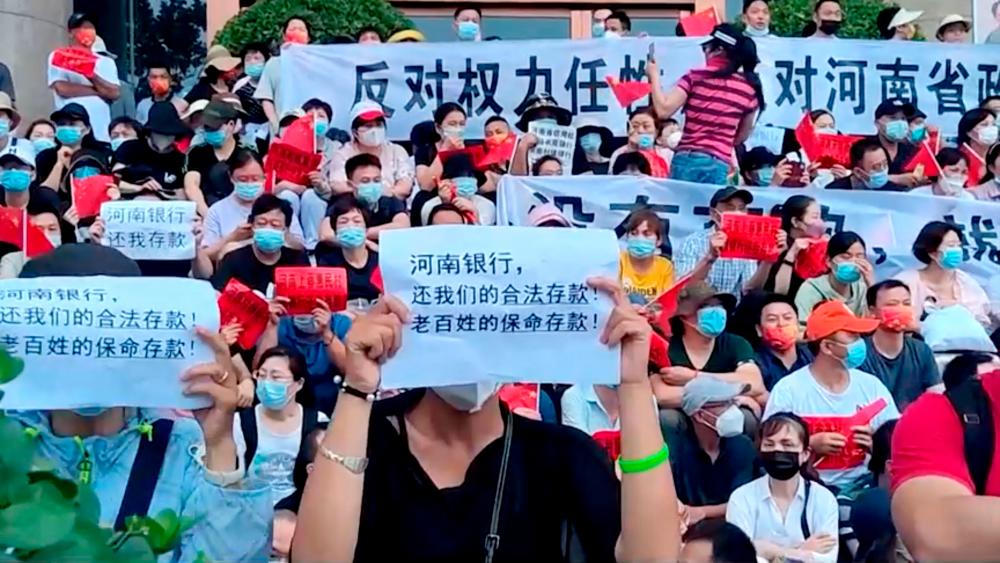 China detains alleged bank fraud ‘gang’ after rare mass protests