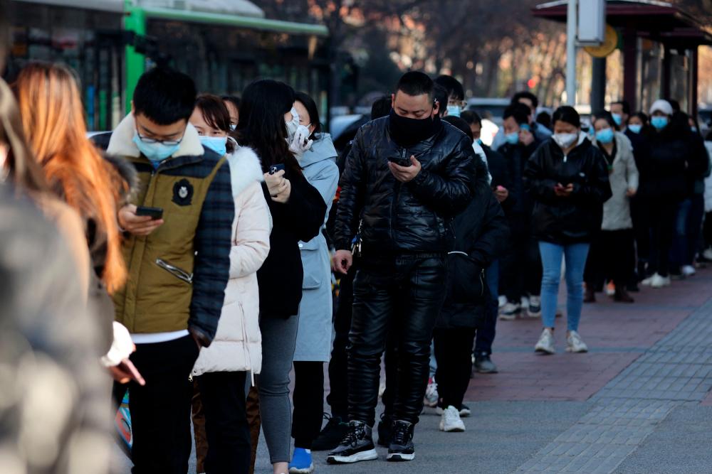 Chinese city sharply restricts travel to fight Covid outbreak