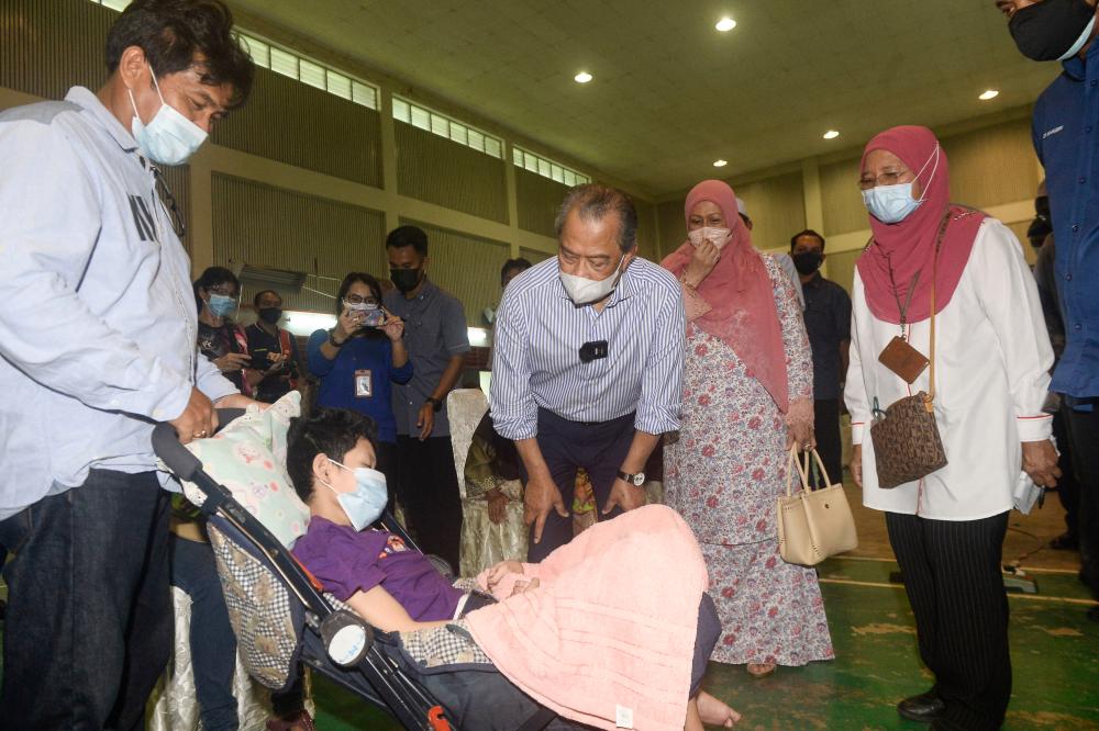 Covid: Muhyiddin jokes with Orang Asli to help allay fears of vaccination