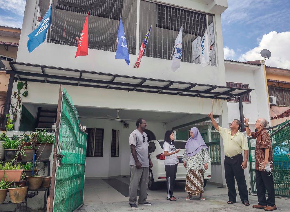 Family in Batu Caves puts up flags of different political coalitions to drive point home