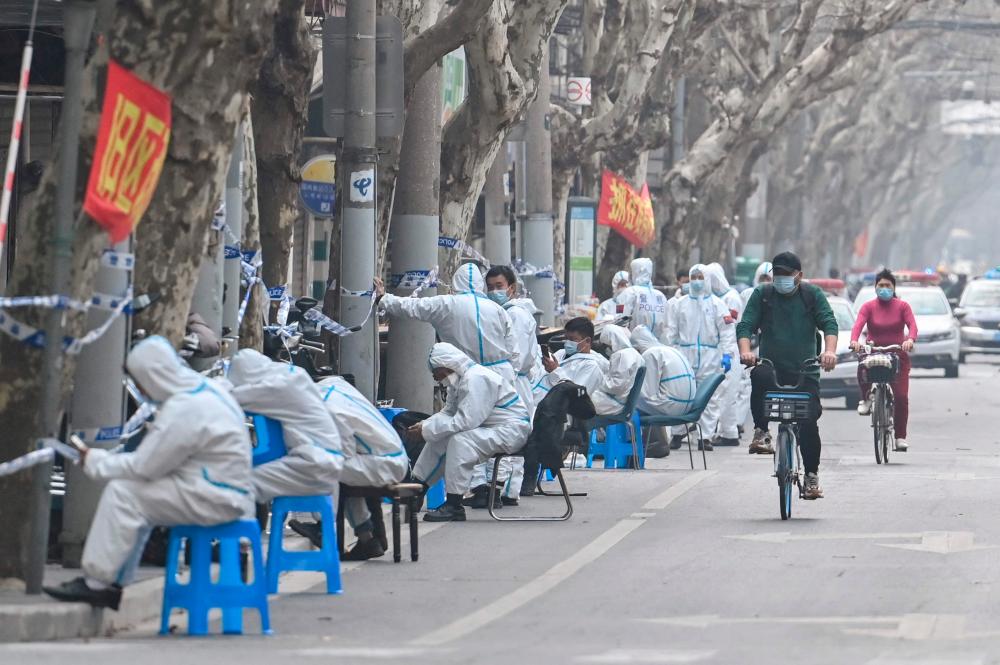 Hazmat suits and panic buying: Pandemic images return to China