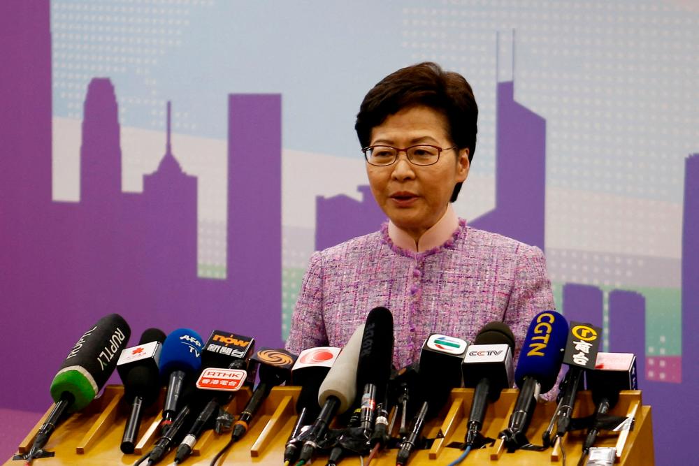 Hong Kong leader orders probe of 13 officials who went to Covid-hit party