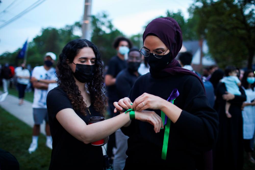 In vigil remembering Canadian Muslim family, a vow that 'this is our city'