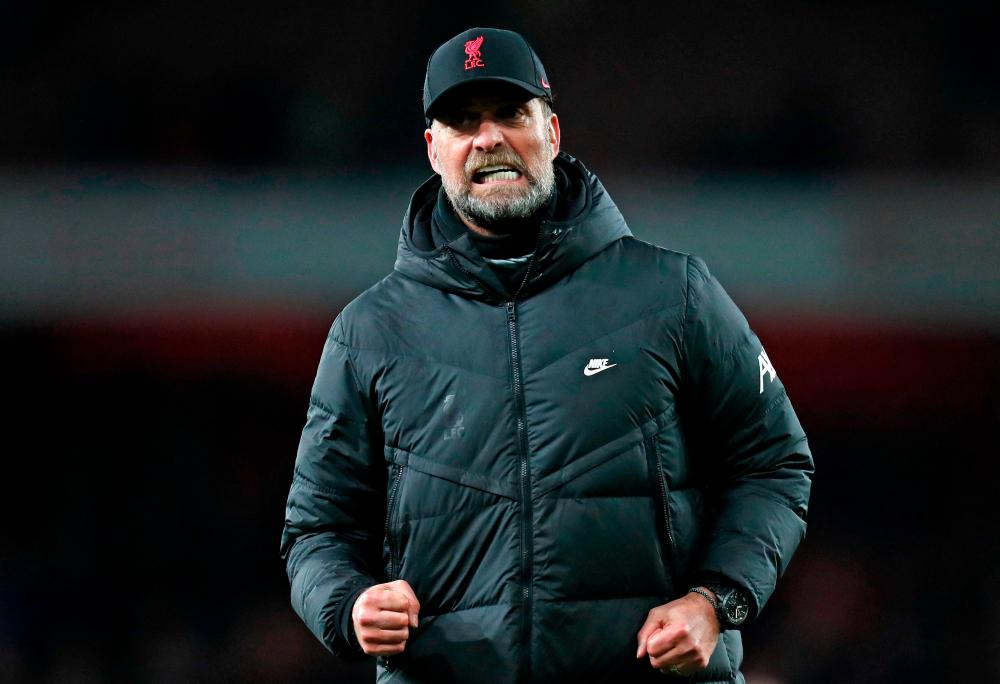 Liverpool sink Arsenal to boost title bid, record-breaker Kane lifts Spurs