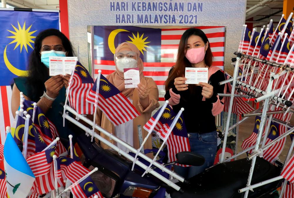 Malaysian family stands proud as country hits target of having 80 pct of adults fully vaccinated Malaysian family stands proud as country hits target of having 80 pct of adults fully vaccinated