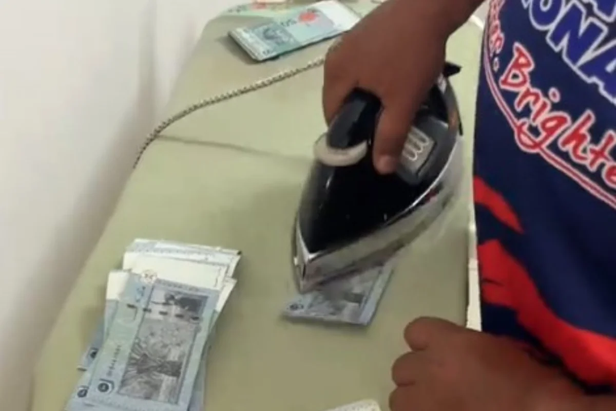 Man_irons_RM50_notes_at_home_for_Raya_due_to_time_crunch