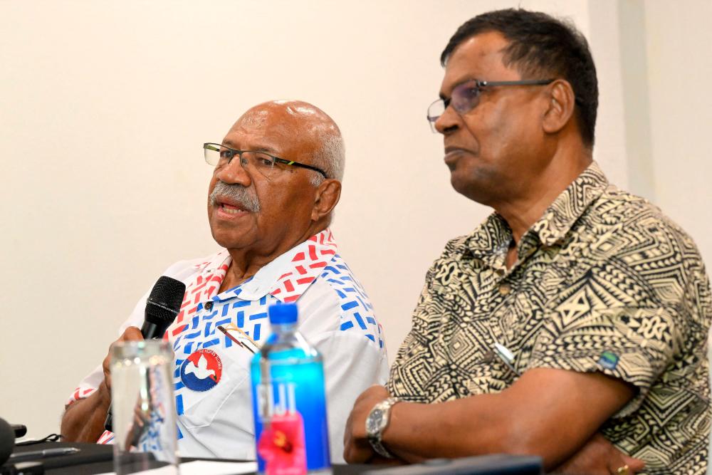 Tense Fiji election tied, opposition eyes deal for power Tense Fiji election tied, opposition eyes deal for power