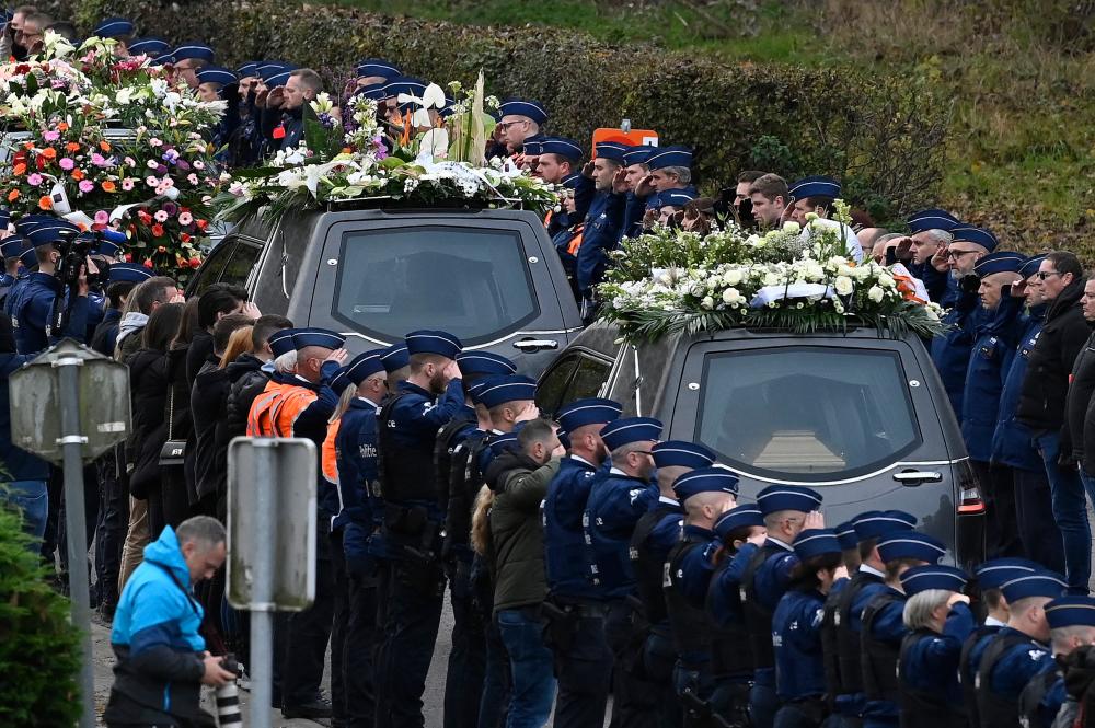 Thousands of Belgian police line streets for funeral of murdered colleague Thousands of Belgian police line streets for funeral of murdered colleague